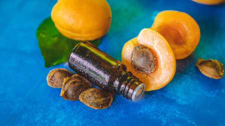 Apricot kernel oil in a bottle. Selective focus. Nature.