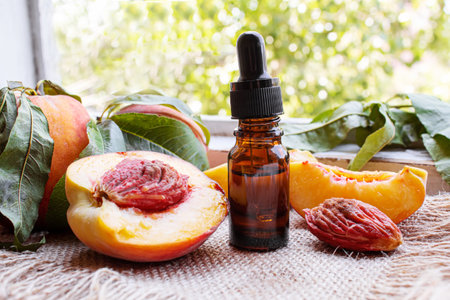 Peach seed oil in a bottle. Selective focus.foodの写真素材
