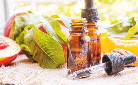 Peach seed oil in a bottle. Selective focus.foodの写真素材