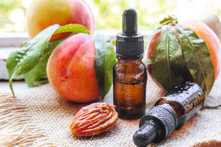 Peach seed oil in a bottle. Selective focus.foodの写真素材