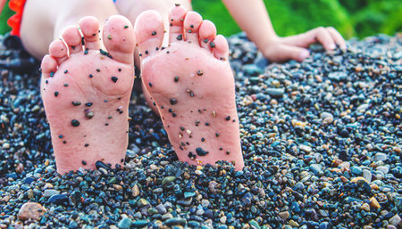 Child feet painted with paints on the sea. Selective focus. Kid.の写真素材