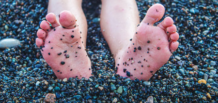 Child feet painted with paints on the sea. Selective focus. Kid.の写真素材