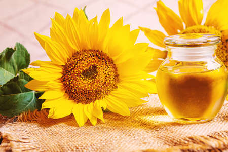 Sunflower seeds and oil bottle on old wooden background. Selective focus.natureの写真素材