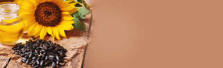 Sunflower seeds and oil bottle on old wooden background. Selective focus.natureの写真素材