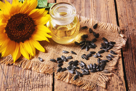 Sunflower seeds and oil bottle on old wooden background. Selective focus.natureの写真素材