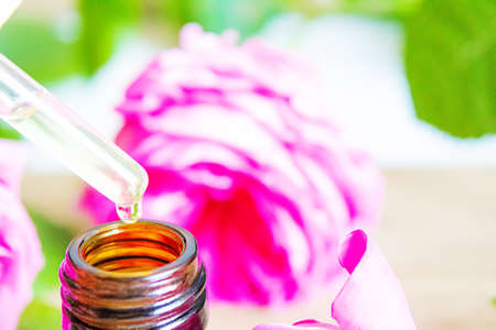 tea rose oil in a small bottle. selective focus.natureの写真素材