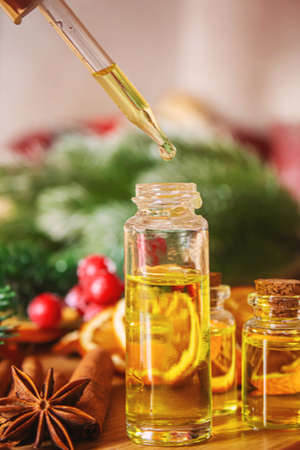 Christmas essential oils in a small bottle. Selective focus. Holiday.の写真素材
