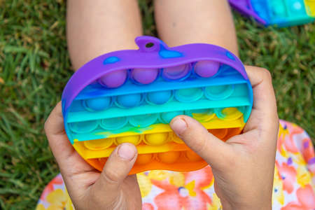 The child plays anti-stress pop it .Selective focus.toyの写真素材