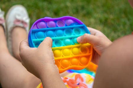 The child plays anti-stress pop it .Selective focus.toyの写真素材