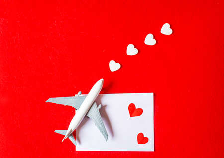 Hearts and a plane on a red background. Valentines Day. Selective focus.の写真素材