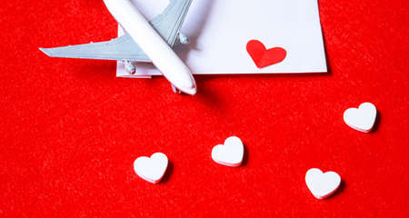 Hearts and a plane on a red background. Valentines Day. Selective focus.の写真素材