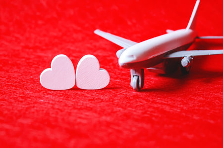 Hearts and a plane on a red background. Valentines Day. Selective focus.の写真素材