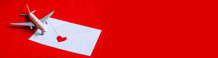 Hearts and a plane on a red background. Valentines Day. Selective focus.の写真素材