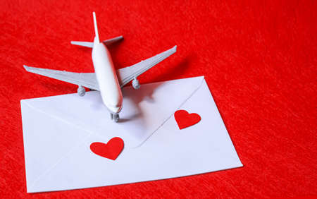 Hearts and a plane on a red background. Valentines Day. Selective focus.の写真素材