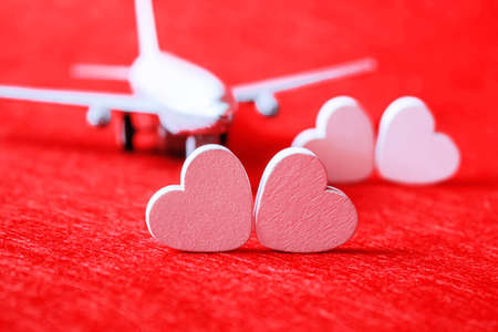 Hearts and a plane on a red background. Valentines Day. Selective focus.の写真素材