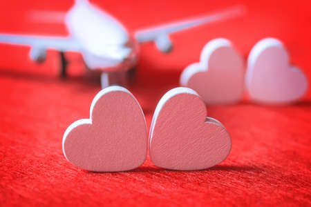 Hearts and a plane on a red background. Valentines Day. Selective focus.の写真素材