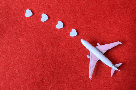 Hearts and a plane on a red background. Valentines Day. Selective focus.の写真素材