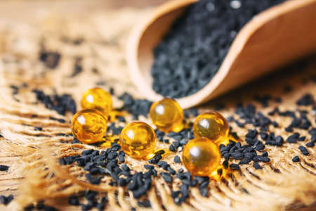 Black cumin essential oil in a small bottle. selective focus. nature.の写真素材