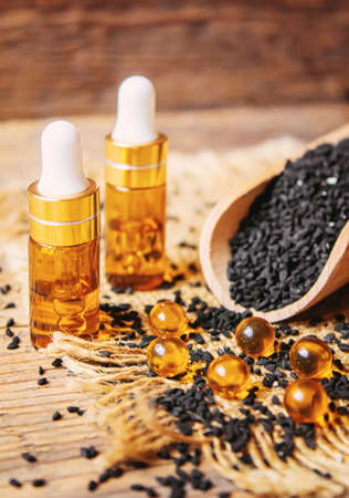 Black cumin essential oil in a small bottle. selective focus. nature.の写真素材