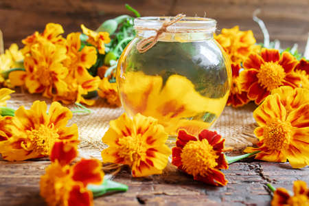 tincture of flowers of Chernobrivtsov in a small jar. selective focusの写真素材