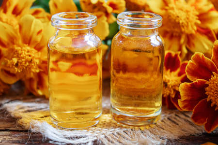 tincture of flowers of Chernobrivtsov in a small jar. selective focusの写真素材