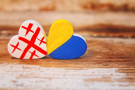 The symbol of the state flags of Ukraine Georgia and Russia is made in the shape of a heart.selective focus.symbolsの写真素材