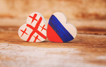 The symbol of the state flags of Ukraine Georgia and Russia is made in the shape of a heart.selective focus.symbolsの写真素材