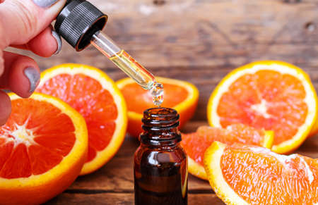 Grapefruit essential oil in a small bottle. selective focus. food.の写真素材