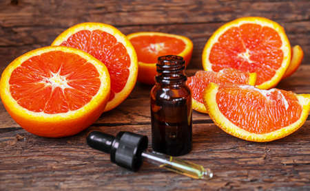 Grapefruit essential oil in a small bottle. selective focus. food.の写真素材