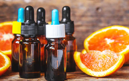 Grapefruit essential oil in a small bottle. selective focus. food.の写真素材