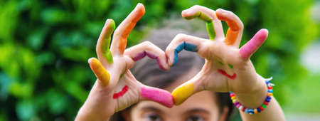 Children's hands in the colors of summer. Selective focus.artsの写真素材