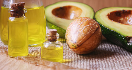 Avocado and avocado oil on wooden background. selective focus foodの写真素材