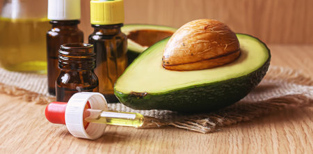 Avocado and avocado oil on wooden background. selective focus foodの写真素材