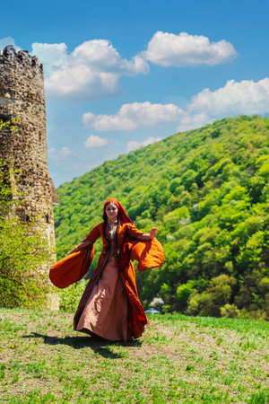 Georgian girl in national costume dances Georgian national dances. selective focus peopleの写真素材