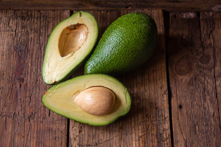 Avocado and avocado oil on wooden background. selective focus foodの写真素材