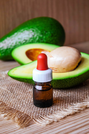 Avocado and avocado oil on wooden background. selective focus foodの写真素材