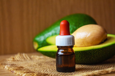 Avocado and avocado oil on wooden background. selective focus foodの写真素材