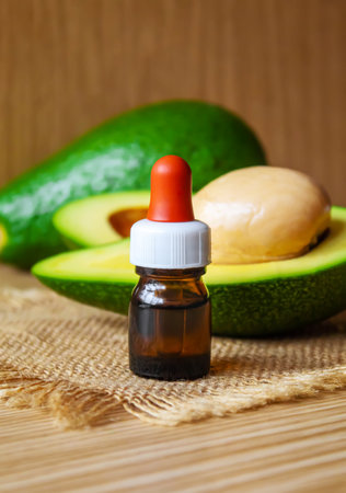 Avocado and avocado oil on wooden background. selective focus foodの写真素材