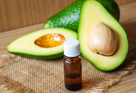 Avocado and avocado oil on wooden background. selective focus foodの写真素材