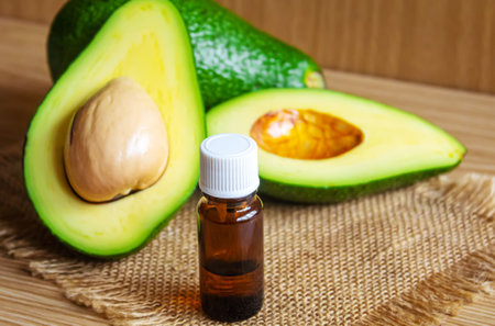 Avocado and avocado oil on wooden background. selective focus foodの写真素材