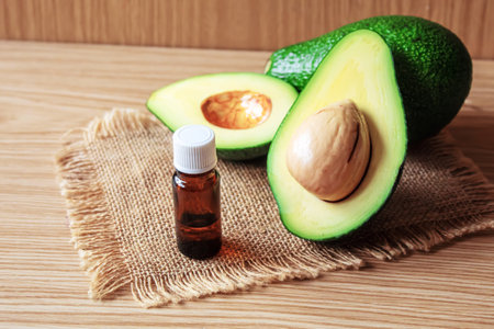Avocado and avocado oil on wooden background. selective focus foodの写真素材