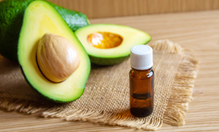 Avocado and avocado oil on wooden background. selective focus foodの写真素材