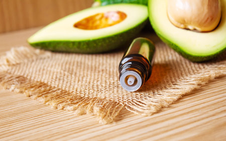Avocado and avocado oil on wooden background. selective focus foodの写真素材