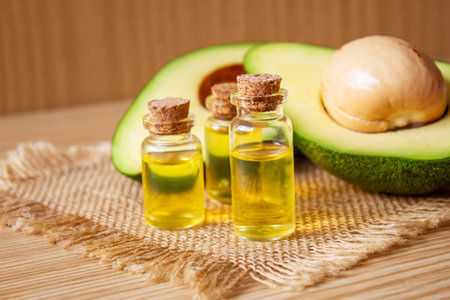 Avocado and avocado oil on wooden background. selective focus foodの写真素材
