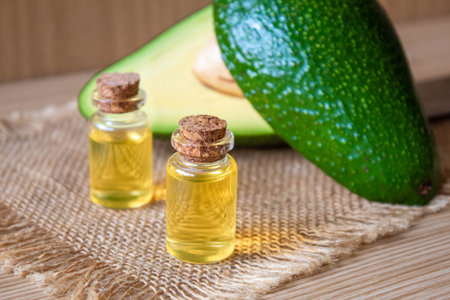 Avocado and avocado oil on wooden background. selective focus foodの写真素材