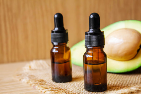 Avocado and avocado oil on wooden background. selective focus foodの写真素材