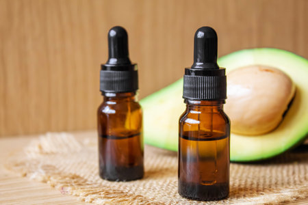Avocado and avocado oil on wooden background. selective focus foodの写真素材