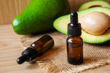 Avocado and avocado oil on wooden background. selective focus foodの写真素材