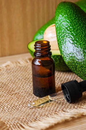 Avocado and avocado oil on wooden background. selective focus foodの写真素材