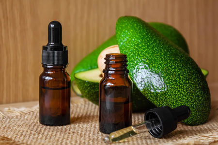 Avocado and avocado oil on wooden background. selective focus foodの写真素材